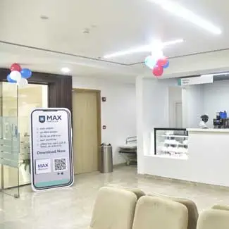 Modern reception area of Gynecology & Obstetrician Department of Max Hospital, Gomti Nagar, Lucknow with a signboard, balloons, seating, and a reception desk.